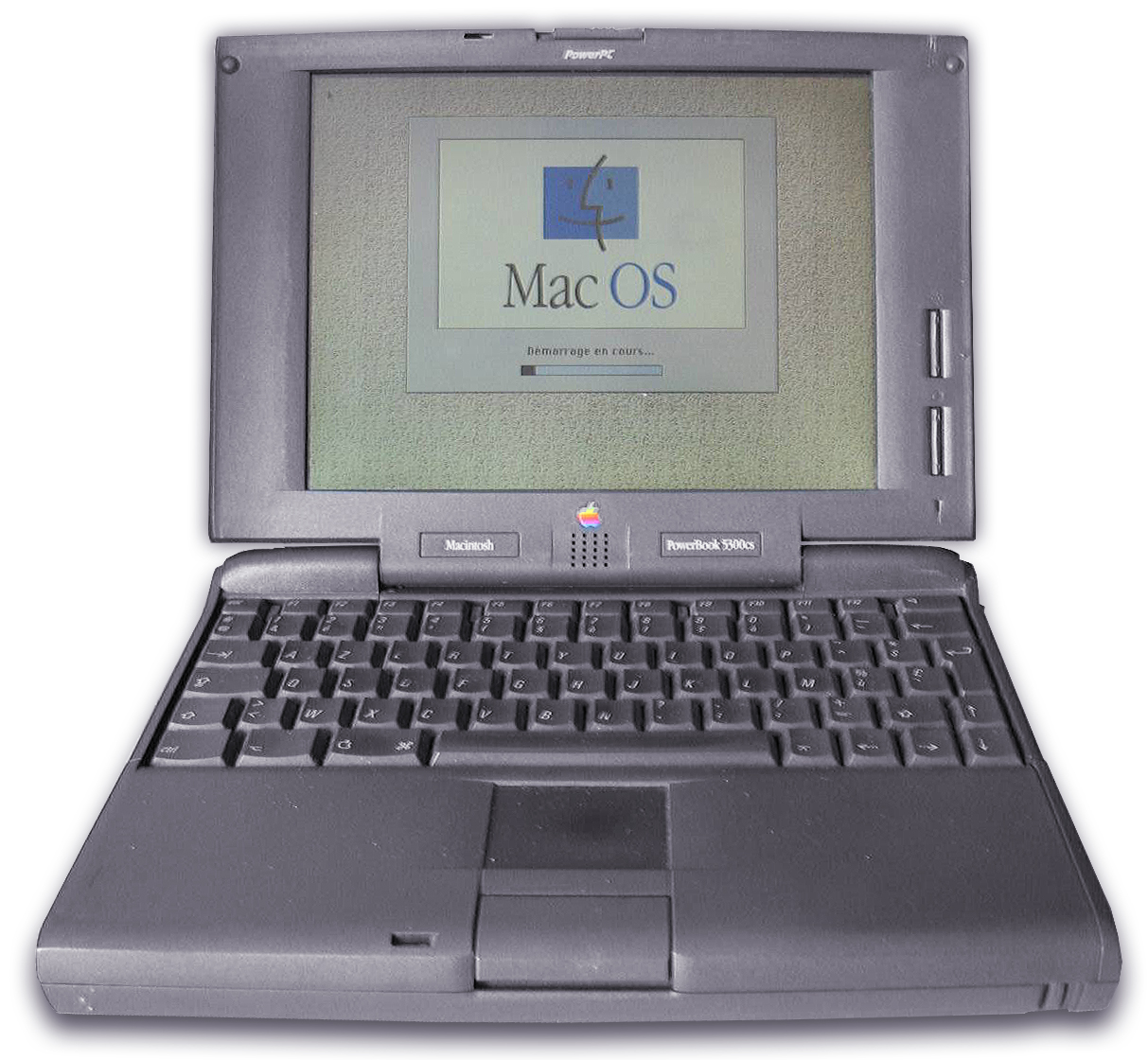 古いMacintosh PowerBook 5300のラップトップ。画面にMac OSの起動中の表示がある。